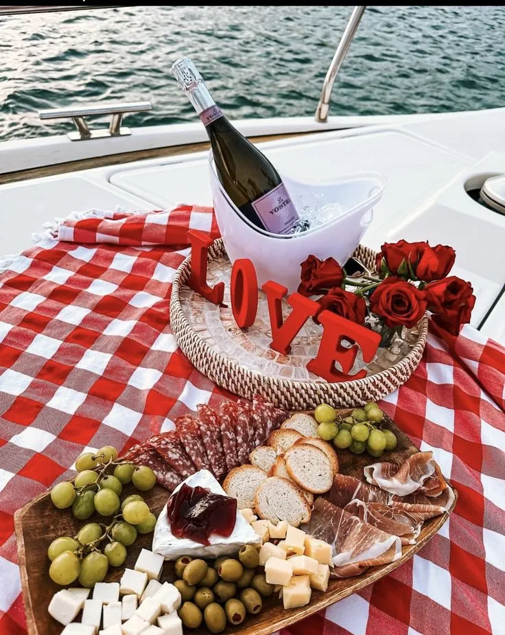 Champagne on ice with a charcuterie board and LOVE letters on the yacht deck
